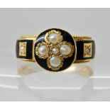 A bright yellow metal hair mourning ring with black enamel, pearls and hair insert, finger size Q,