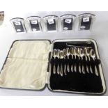 A lot comprising a cased set of twelve silver coffee spoons with tongs, Sheffield 1931 and five