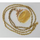 A 9ct gold citrine fob seal approx 3.3cm x 3cm, with a gold plated long rope chain, weight of the
