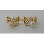 A pair of 18ct gold double pearl earrings with post and clip fitting, length 19cm, weight 6.8gms