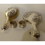 A lot comprising a silver backed brush and mirror, Birmingham 1909 and a pair of white metal