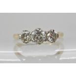 An 18ct gold and platinum three stone diamond ring of estimated approx combined 0.64cts, finger size