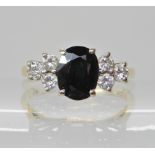 An 18ct gold sapphire and diamond ring, sapphire approx 7.8mm x 5.99mm x 3.4mm, diamond content