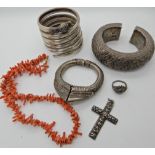 A white metal Indian snake bangle, other white metal ethnic items and a string of coral beads