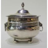 A silver tea caddy with lion mask handles by George Nathan & Ridley Hayes, Chester 1915, 10cm high x