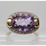 A 9ct amethyst and diamond dress ring head size 13.5mm x 19.7mm, size T1/2, weight 5.2gms