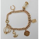 A 9ct gold charm bracelet hung with four 9ct gold charms and one in yellow metal, (clasp is not