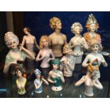 A collection of porcelain half dolls, various sizes, largest 16cm high Condition Report: Available