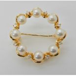 An 18ct gold Mikimoto diamond and pearl brooch diameter 2.5cm, weight 4.3gms, in original box