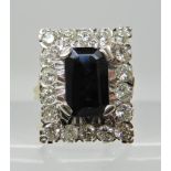 An 18ct gold sapphire and diamond oblong cluster ring, sapphire approx 10.5mm x 6.5cm x 3.7cm,