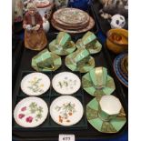 A set of six Royal Doulton coffee cups and saucers, decorated in green and gilt, a Royal Doulton