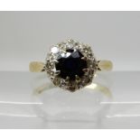 An 18ct gold sapphire and diamond cluster ring, set with estimated approx 0.16cts of diamonds,