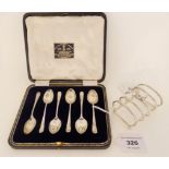 A lot comprising a cased set of six silver coffee spoons, Sheffield 1922 and a silver toastrack,