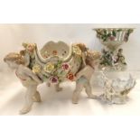 A large Continental porcelain centre bowl, with cherub figures and relief flowers, 25cm high,