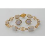 A 14k gold Chinese symbol and grey hardstone bracelet with matching earrings, combined weight 10.