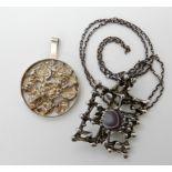 A silver retro pendant by Danish designer Kjeld Bjarne Christensen and a further un-named example in