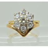 A yellow metal diamond flower ring with matching wedding ring, the flower ring is set with estimated