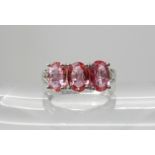 An 18ct white gold three padparadscha sapphire ring, size N1/2, weight 5.5gms Condition Report: