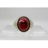 A silver gilt Edinburgh hallmarked signet ring, set with a garnet cabouchon, finger size U, weight