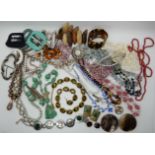 A collection of vintage costume jewellery to include, a green glass pixie necklace, shell beads