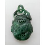 A Chinese green hardstone pendant pomander (cork stopper missing) carved with a rat and fruiting