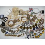 A collection of vintage costume jewellery to include, carved Lucite items, snake bangle etc