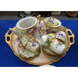A Limoges porcelain tray, handpainted with flowers, a teapot (no lid), sucrier, two small jugs, cups