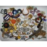 A collection of vintage costume jewellery to include, a retro brooch, Coke can pendant, etc