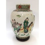 A Chinese famille verte porcelain jar and cover, decorated with a man on horseback, with