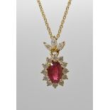 An 18ct gold ruby and diamond cluster pendant and chain, ruby measures approx 6mm x 4mm x 2.3mm,