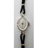A 14k gold ladies Hamilton watch set with diamonds, weight including strap and mechanism 9.4gms