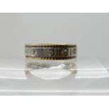 A yellow and white metal band ring set with diamonds finger size M1/2, weight 4.1gms (hallmark