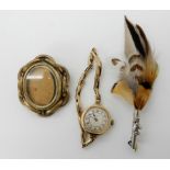 A 9ct gold ladies The Angus wristwatch weight including mechanism 21.5gms, a feather brooch and a