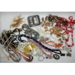 A collection of vintage costume jewellery to include, shell beads, Deco buckles, Deco clip etc