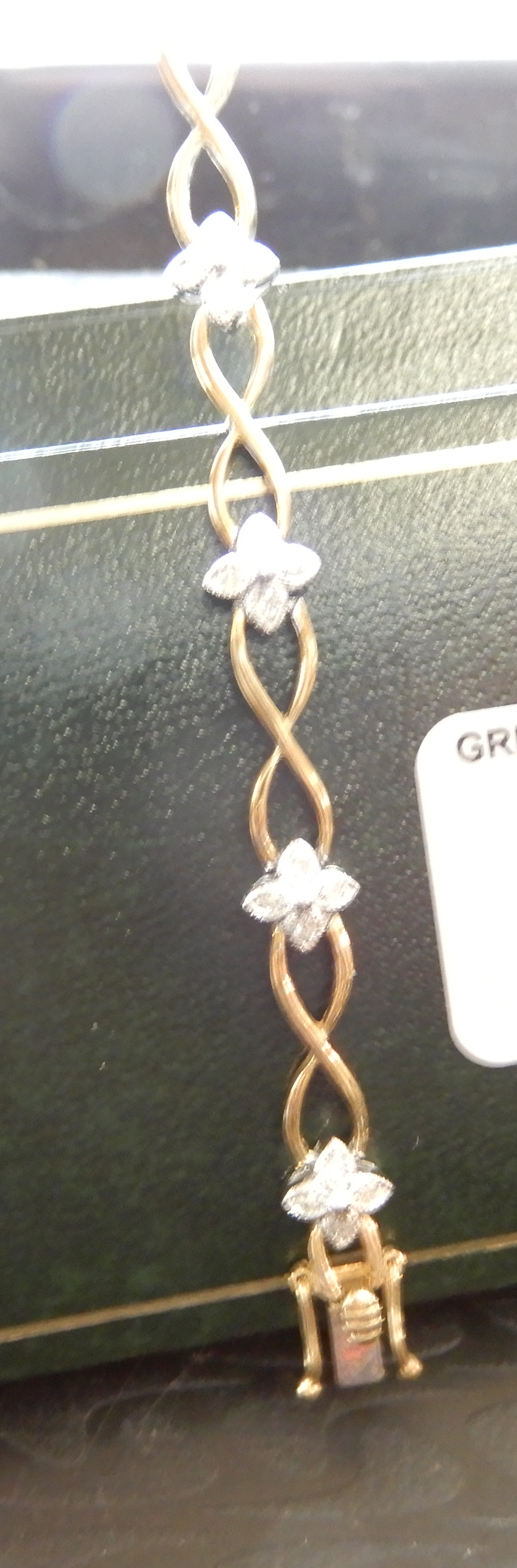 A 9ct gold diamond flower bracelet, set with 0.25cts of eight cut diamonds, length 18cm, weight 8. - Image 3 of 3