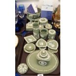 A collection of Wedgwood green jasperware including a tea caddy, 16.5cm high, two oval dishes,