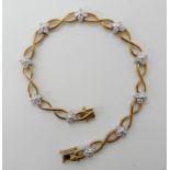 A 9ct gold diamond flower bracelet, set with 0.25cts of eight cut diamonds, length 18cm, weight 8.
