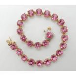 A 9ct gold pink gemstone and diamond bracelet, length 20cm, weight 9.6gms Condition Report: