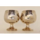 A pair of silver brandy goblets by A. T. Cannon, Sheffield 1973, 8.2cm high, 189gms Condition