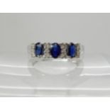 A 9ct white gold sapphire and diamond linear cluster ring, sapphires approx 5mm x 3mm, and set