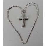 An 18ct white gold diamond set cross set with estimated approx 0.50cts of baguette and princess