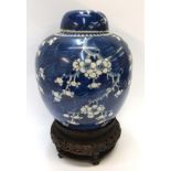 A large Chinese prunus jar and cover, double circle mark to base, 26cm high, with wood stand (2) (