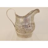 A silver cream jug, rubbed makers marks, London 1804, of helmet shape with scrolling handled and