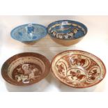 Four Middle Eastern pottery bowls, two decorated with figures on horseback, 24.5cm diameter (chip to