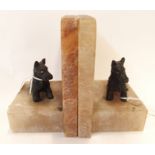 A pair of Deco alabaster bookends, each with a figure of a Scottie dog, 13cm high (2) Condition