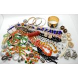 A collection of vintage costume jewellery to include, a green and black glass flapper necklace,