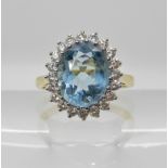 An 18ct gold aquamarine and diamond cluster ring dimensions of the aqua approx 11mm x 9mm x 5.4mm,