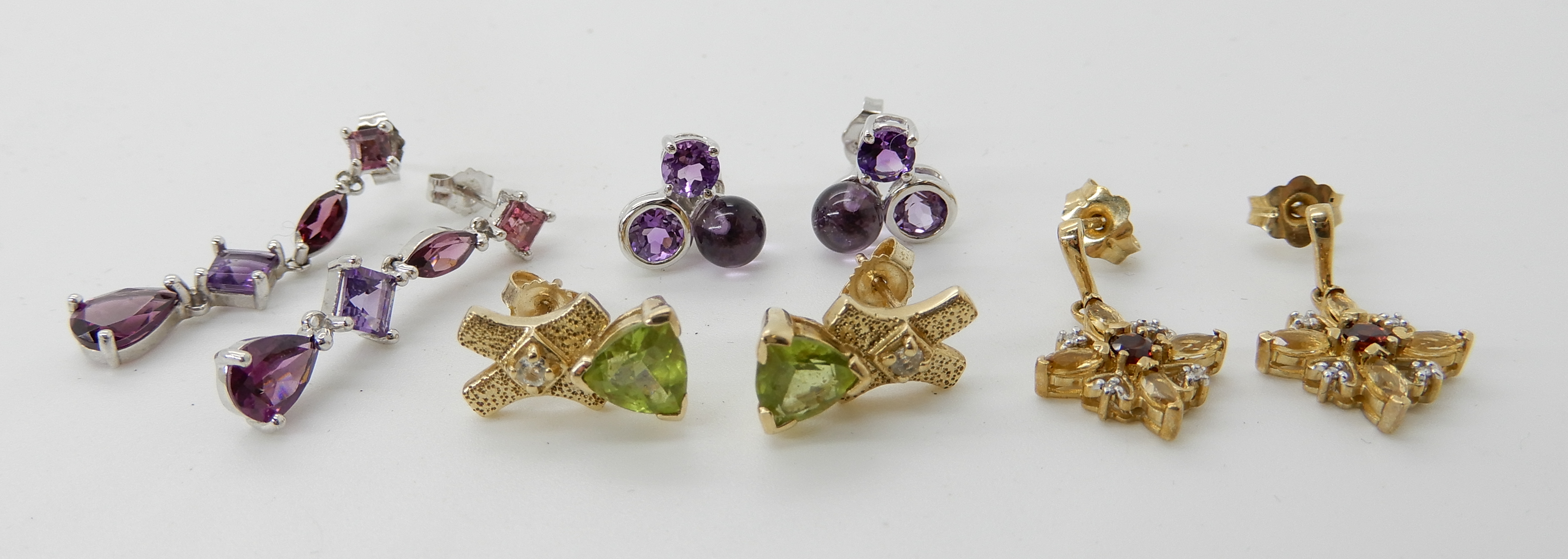 A pair of 9ct gold peridot and diamond earrings, diamond and garnet earrings and two pairs of - Image 2 of 2