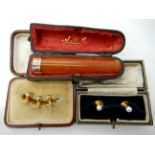 A 9ct gold mounted amber cheroot holder weight 9.8gms, two 15ct gold and pearl studs 2.3gms and