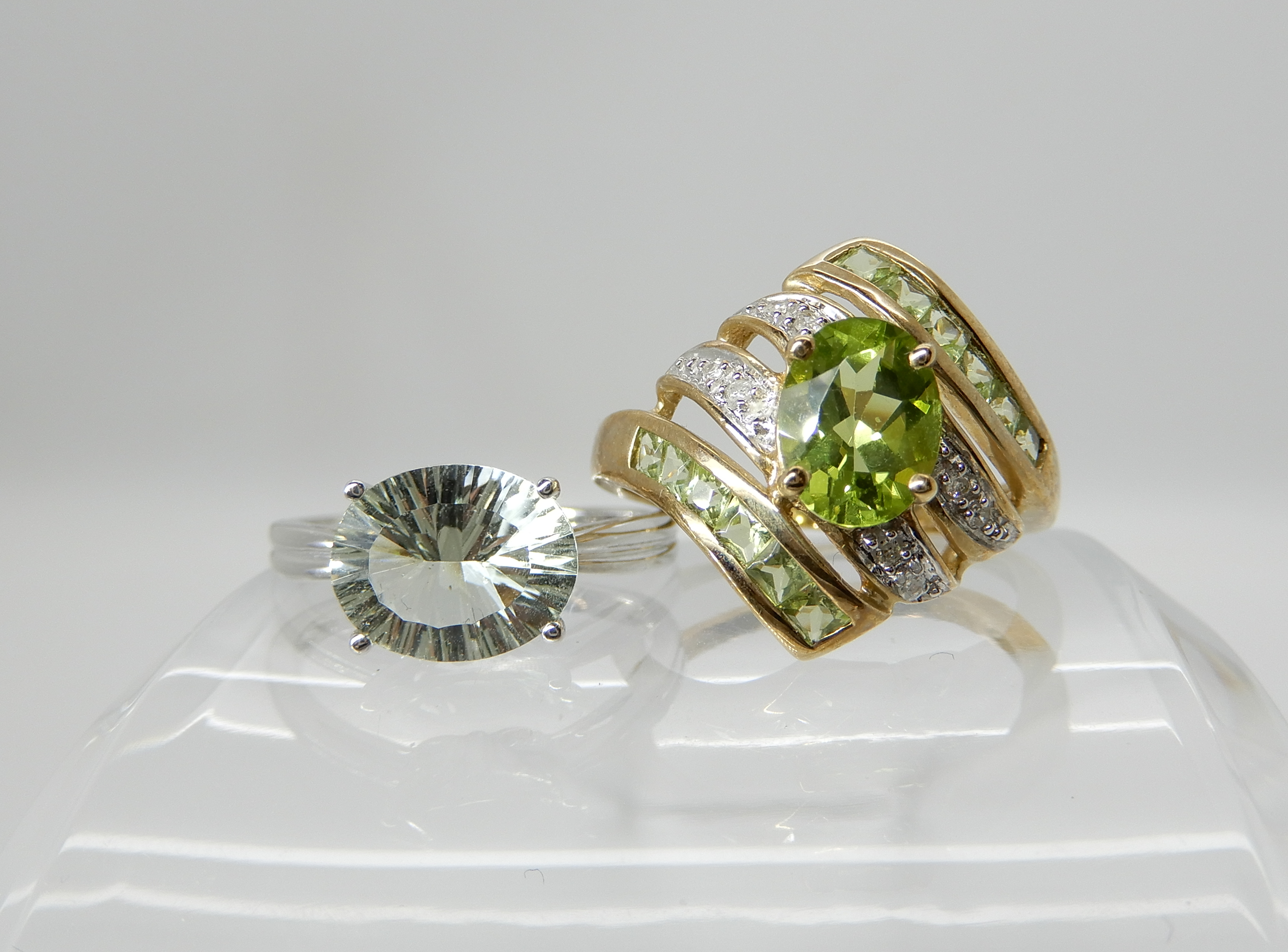 A 9ct gold peridot and diamond dress ring size Q1/2 and a 9ct white gold pale blue gemstone ring,
